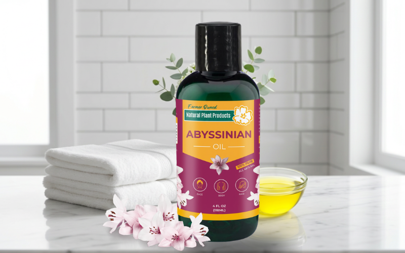 Premium Abyssinian Oil bottle by Natural Plant Products, farmer-owned scalp and hair oil for deep repair and hydration, shown with flowers and towels