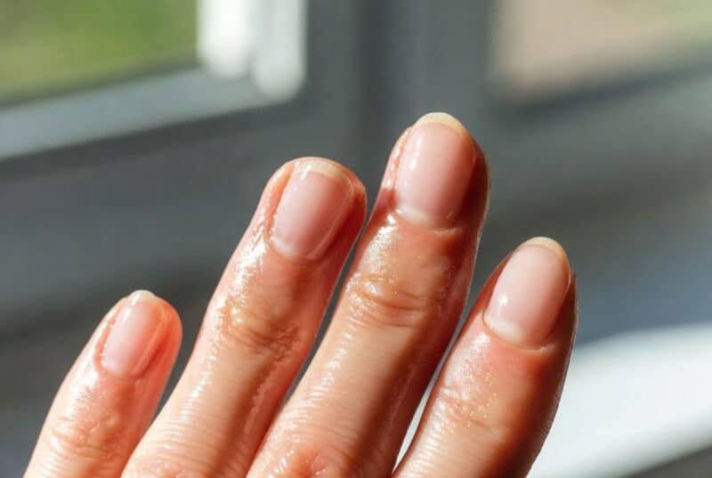 Close-up of healthy hydrated fingernails and soft smooth cuticles after using best natural cuticle oil, showing nourished and repaired skin from botanical oils