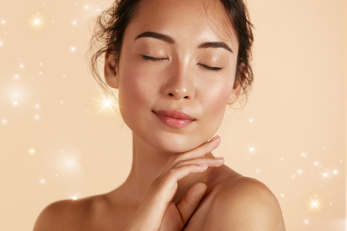 Two people inspecting meadowfoam flowers in a field to assess plant growth and seed quality